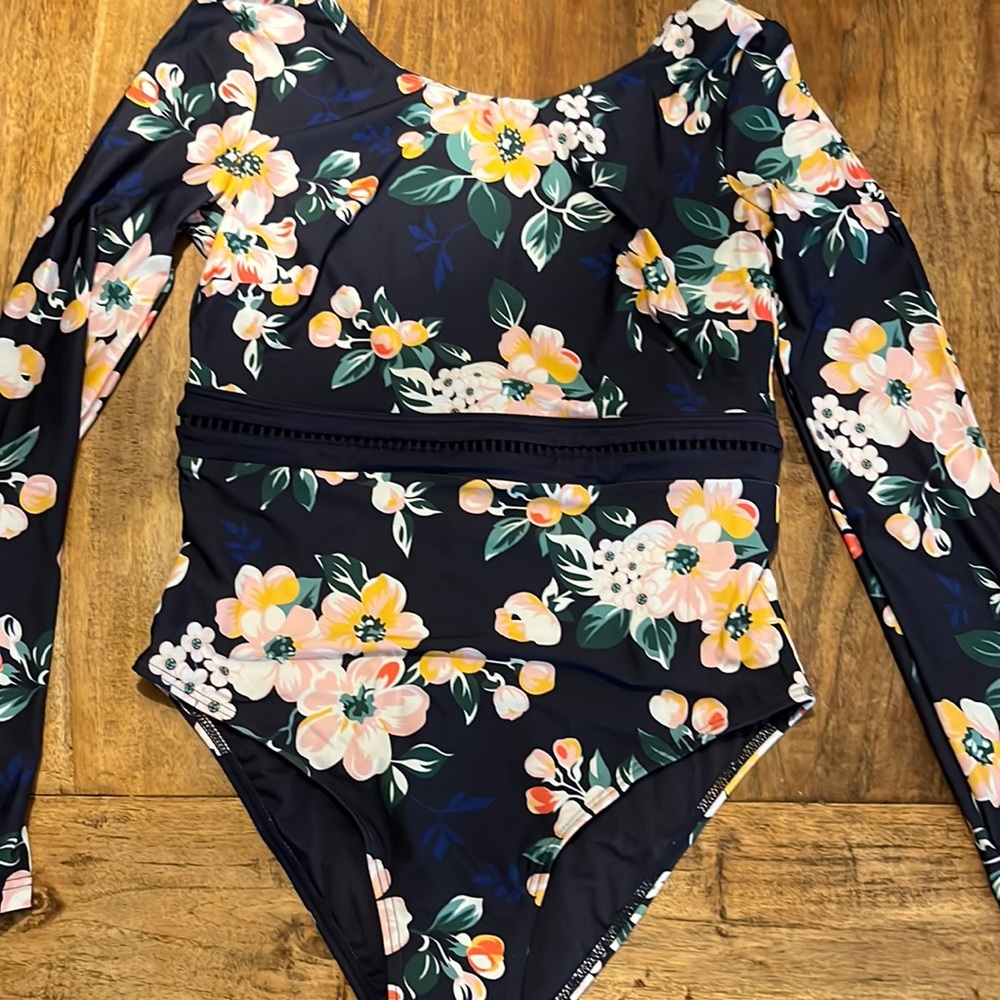 New Long sleeve 1 piece bathing suit with open back. Top is not lined with cups